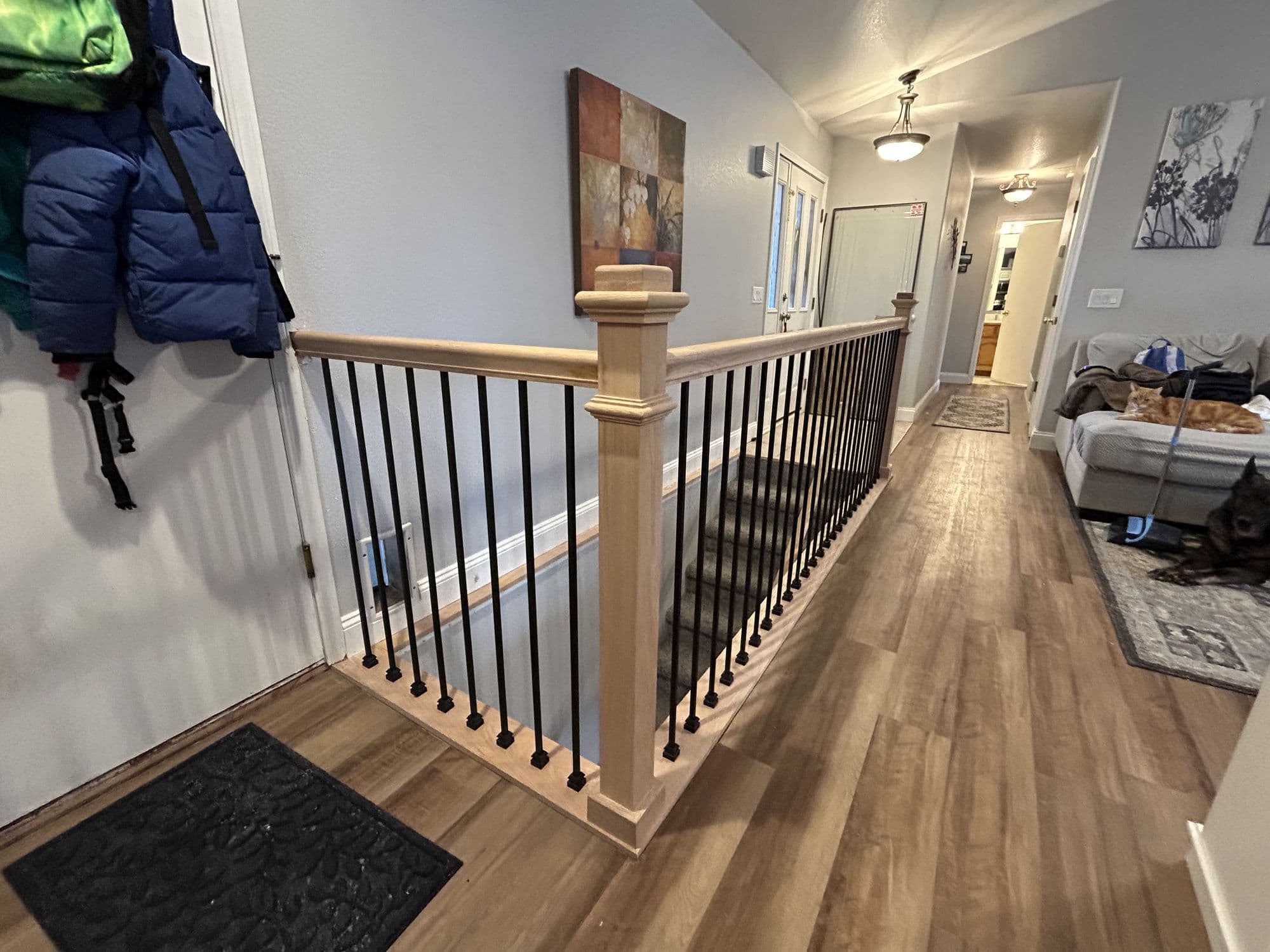 Custom handrail and newel post along a stairway landing