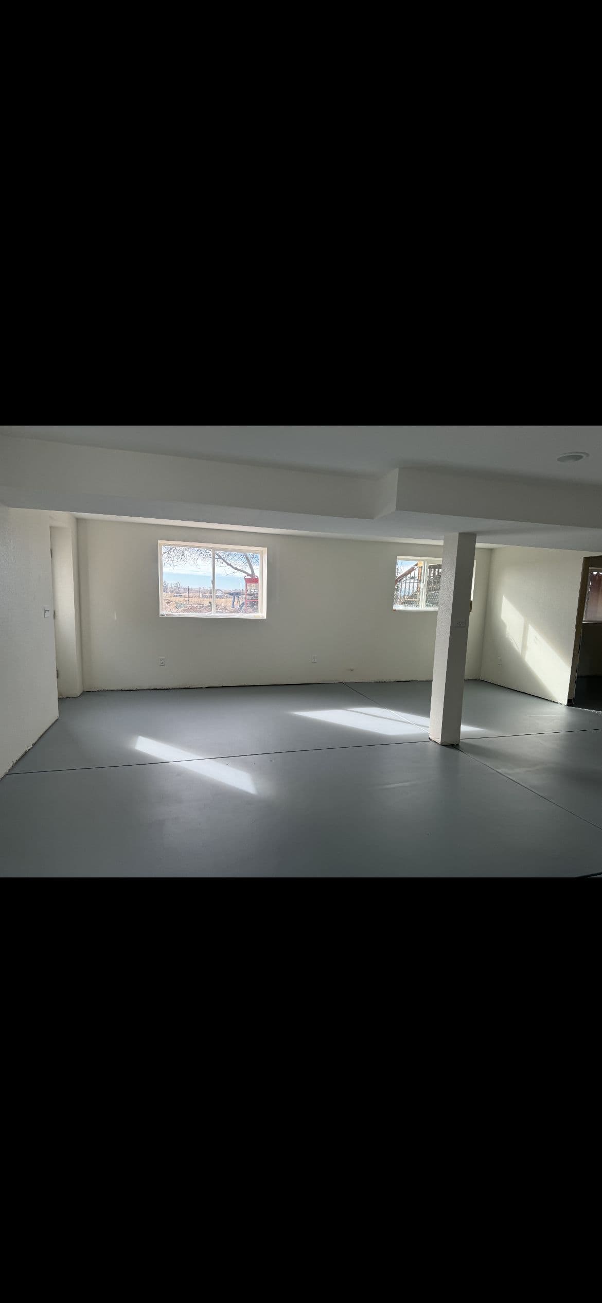 Finished basement room with drywall, ready for paint