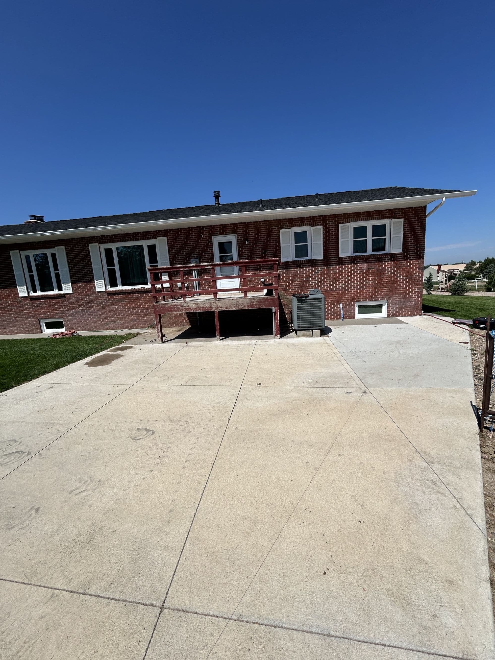 Bare concrete patio before a pool deck build