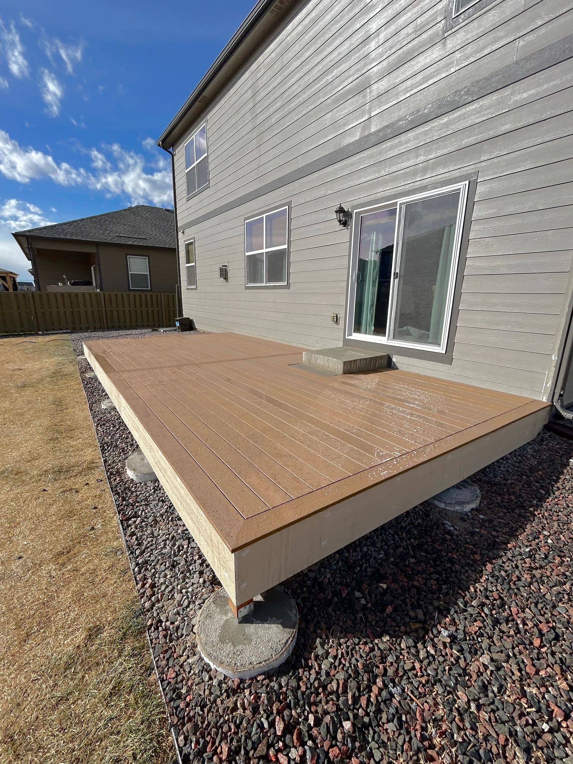 Newly built composite deck attached to a two-story home